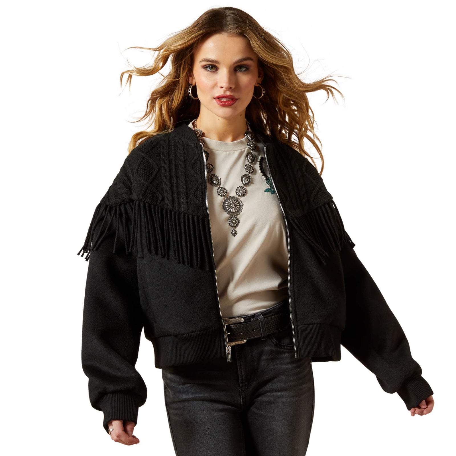 Woman wearing a black fringed jacket on a white background