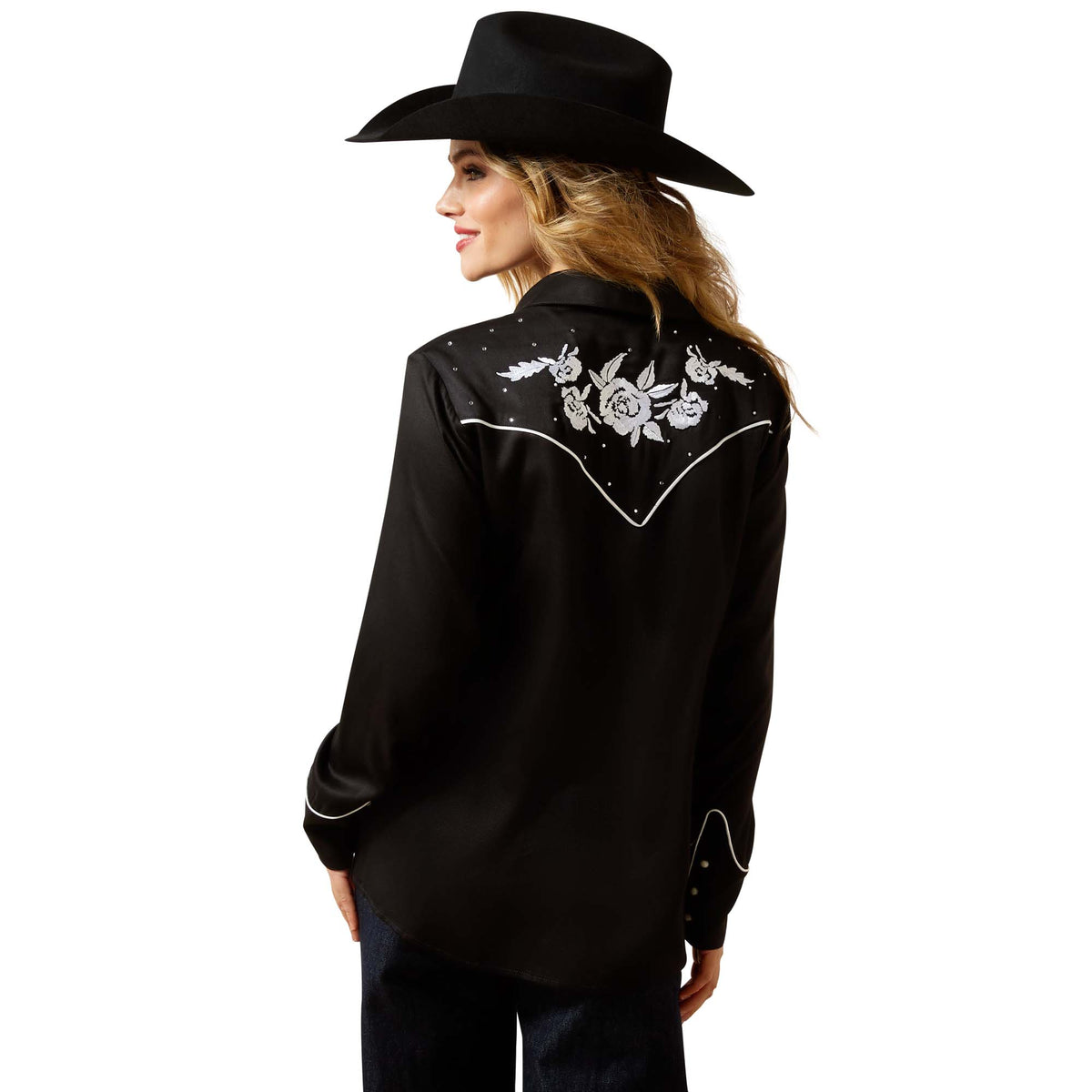 Person wearing a black embroidered shirt and cowboy hat on a white background