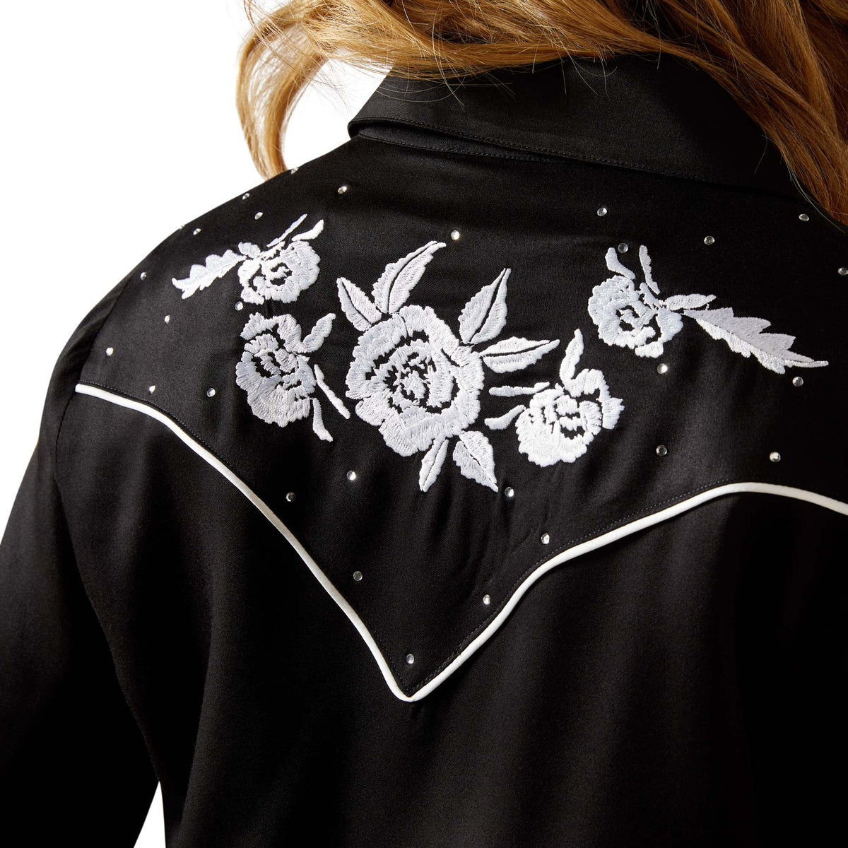 Black jacket with white floral embroidery on a plain background