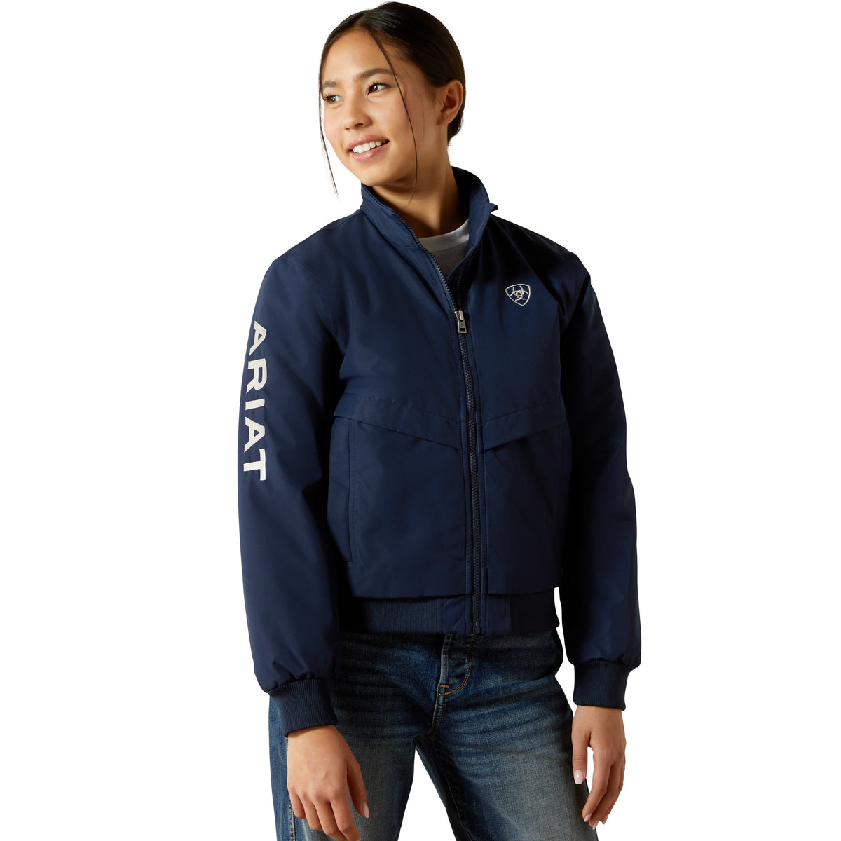 Person wearing a navy blue Ariat jacket on a white background
