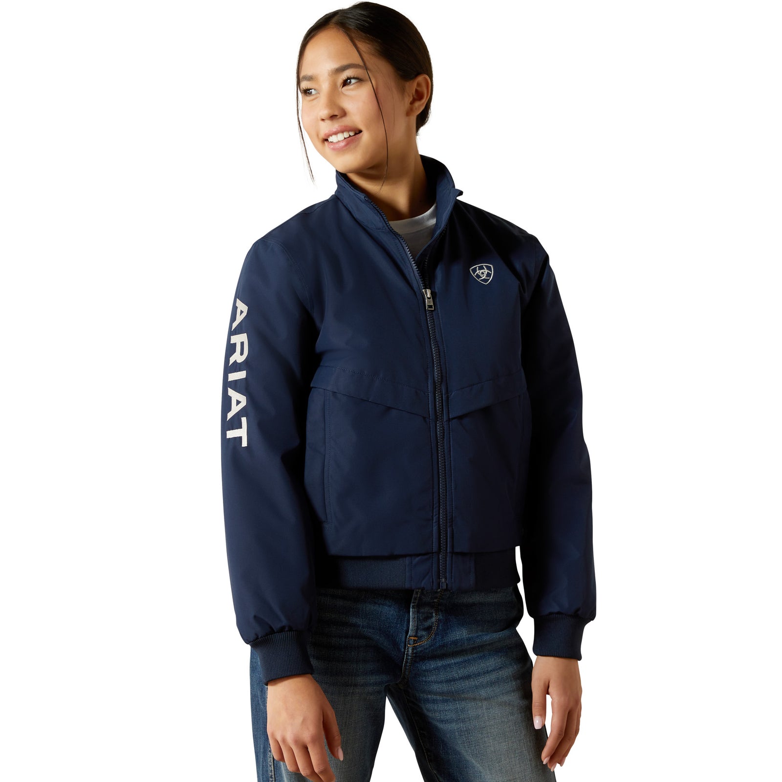 Person wearing a navy blue Ariat jacket on a white background