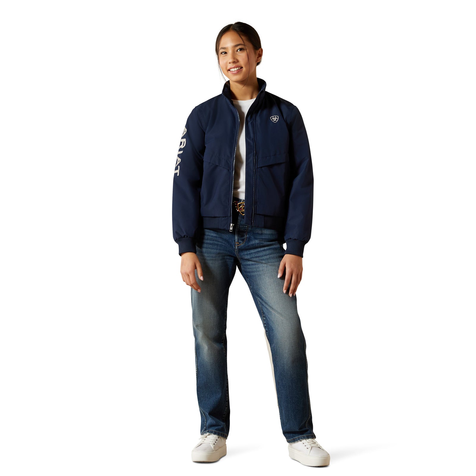 Person wearing a navy jacket with branding on a white background