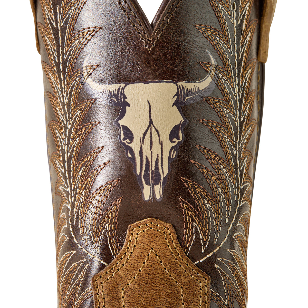 Ariat Stampede Wide Square Toe Kids Western Boot. Close-up of a boot with intricate leatherwork and a longhorn skull design on a white background.