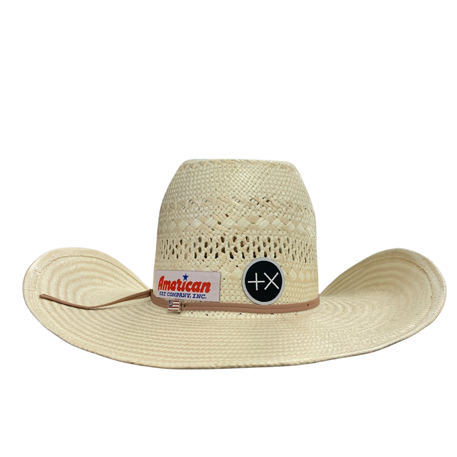 A light beige woven straw cowboy hat with a tan band, featuring a 'American Cowboys Steel' logo patch and a circular black button with a white 'TX' monogram on the front of the crown.