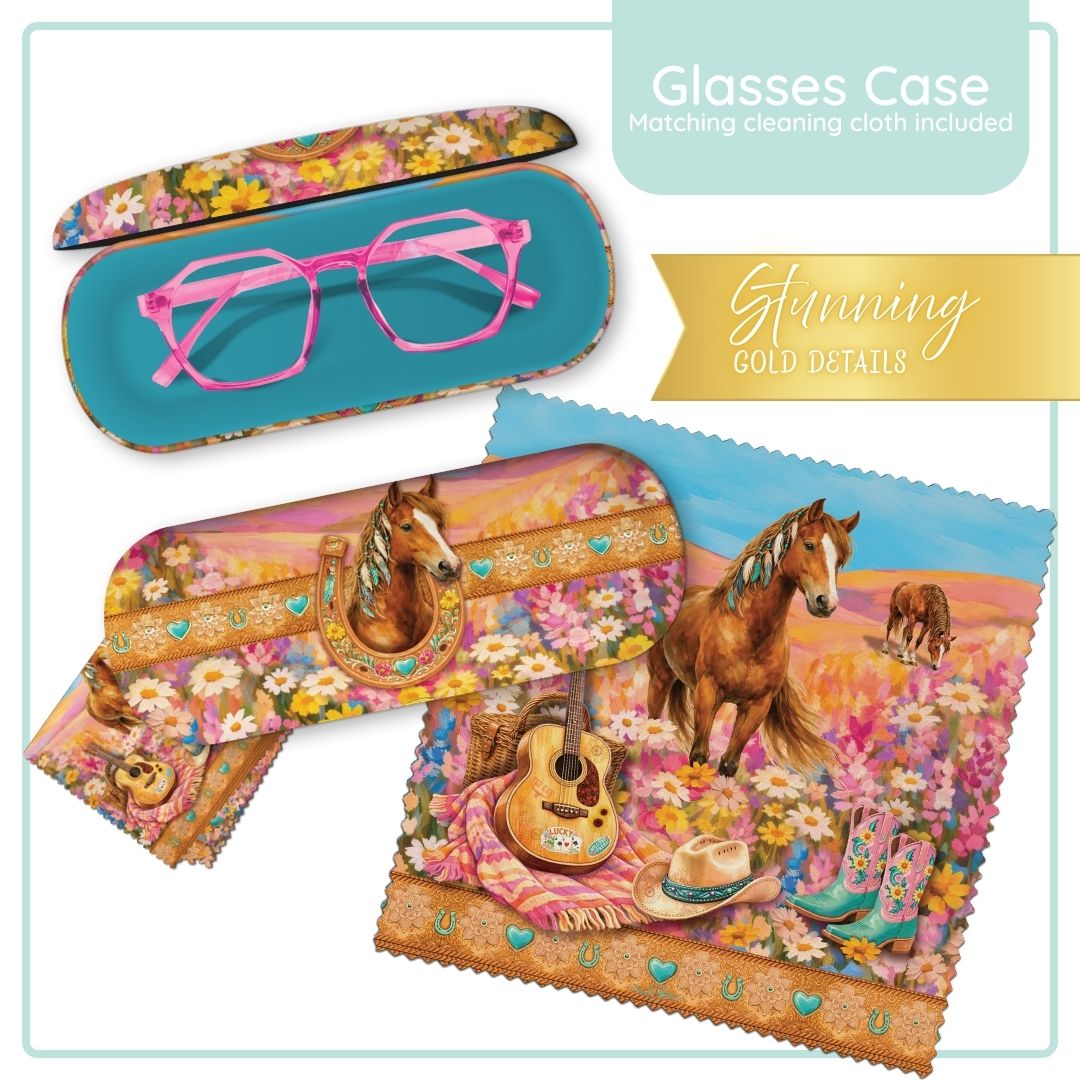 A set of glasses with pink frames shown alongside matching floral and western-themed cleaning cloths and a case. The cloths feature horses, flowers, a guitar, boots, and a cowboy hat in a colorful floral landscape.