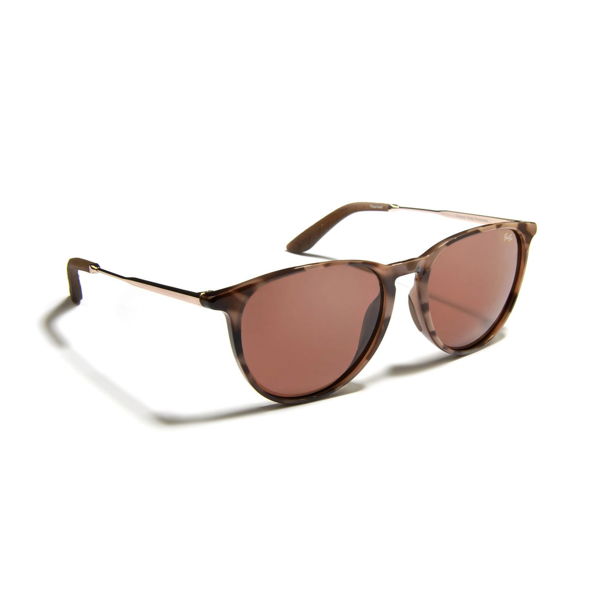 Gidgee Eyes Charisma Auburn Sunglasses. A pair of sunglasses with a leopard tortoise frame and rose tinted lenses, featuring rose gold alloy temple arms with tan grips and replaceable nose pads.