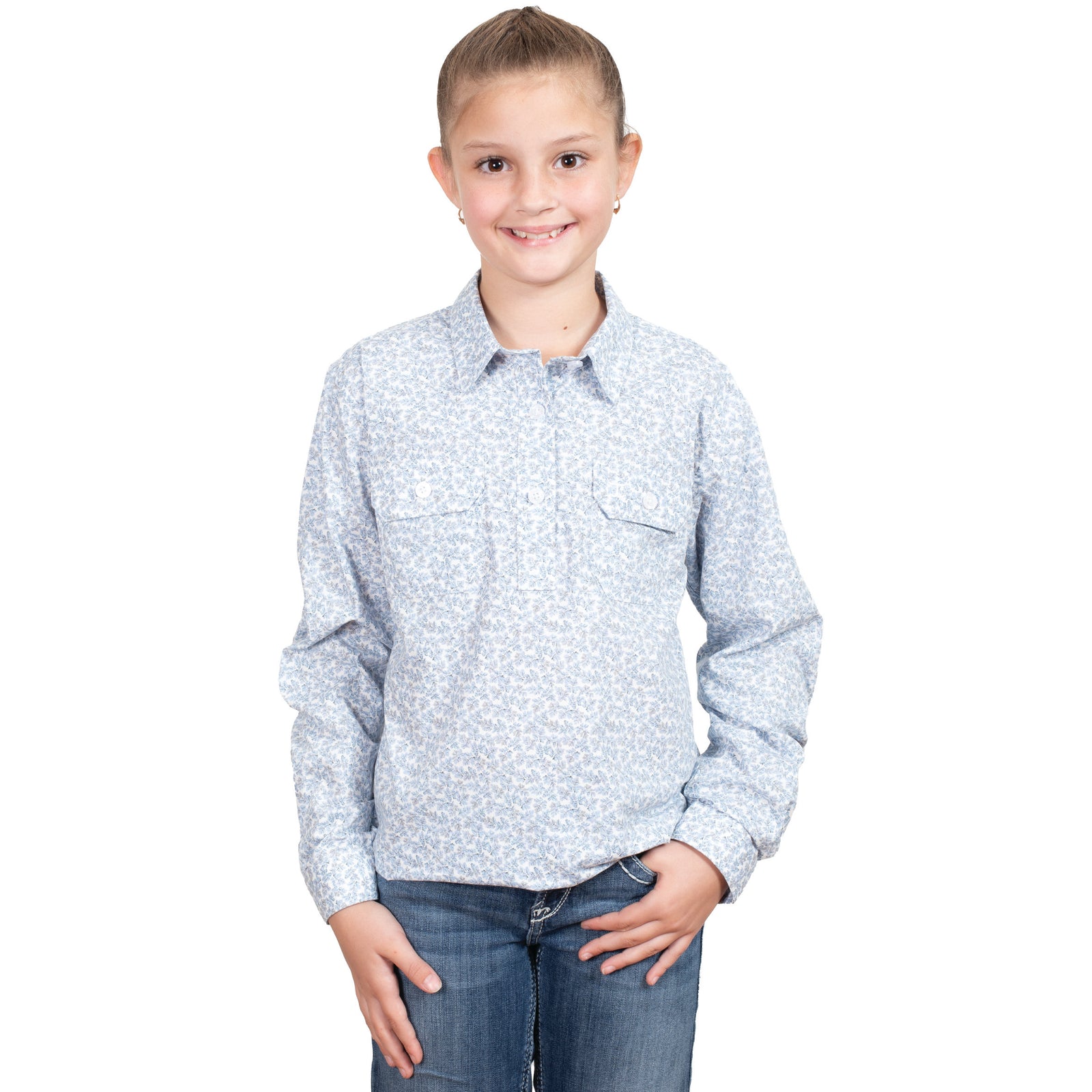 Just Country Girl's Harper Half Button L/S Shirt. A girl wearing a long-sleeved, half-buttoned shirt with double pockets, in a floral pattern, standing against a white background.