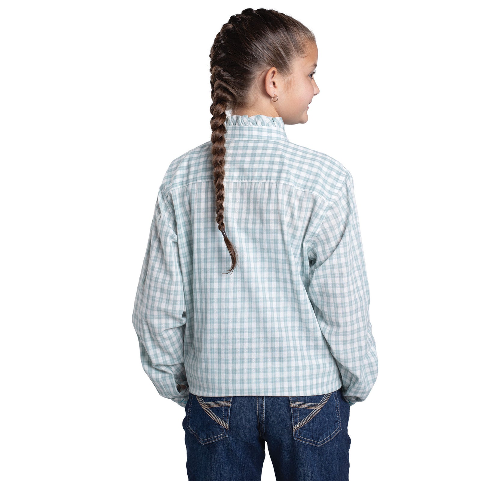 Young girl wearing a light blue checkered shirt and dark jeans on a white background