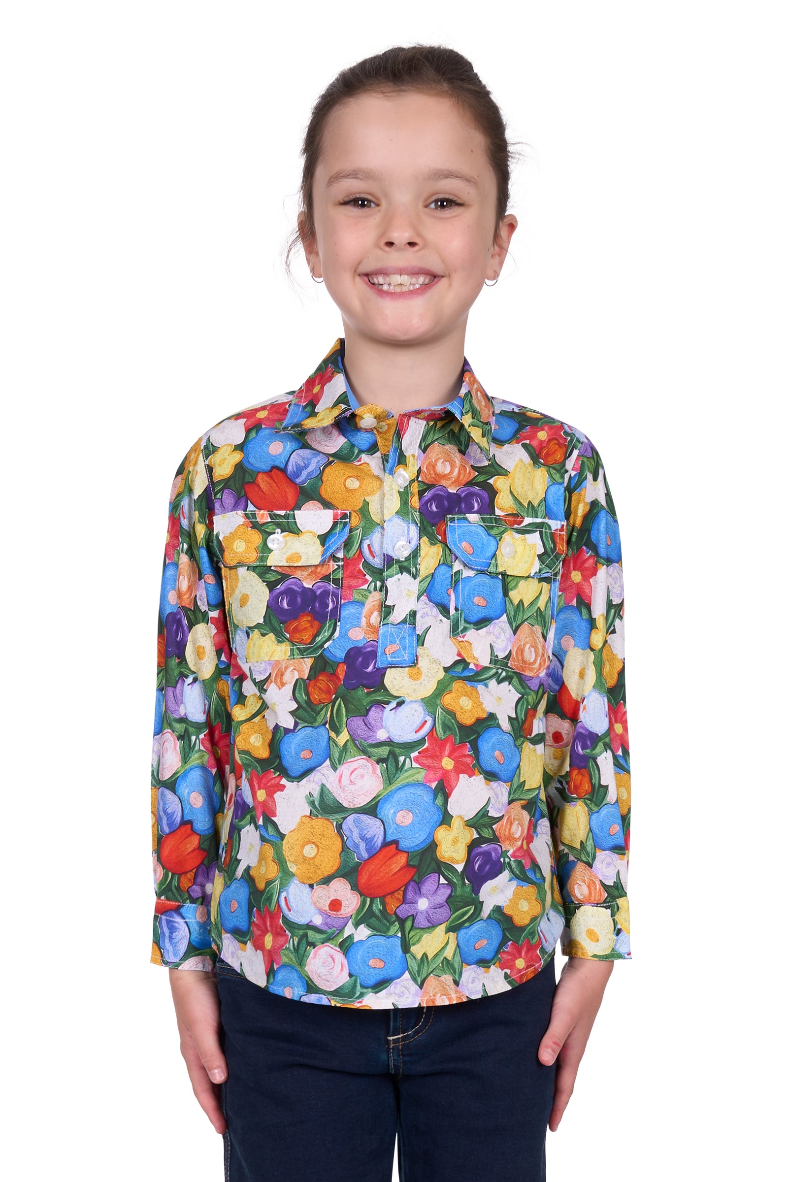 Hard Slog Girl's Delia 1/2 Placket L/S Shirt. Girl wearing a colorful floral shirt on a white background