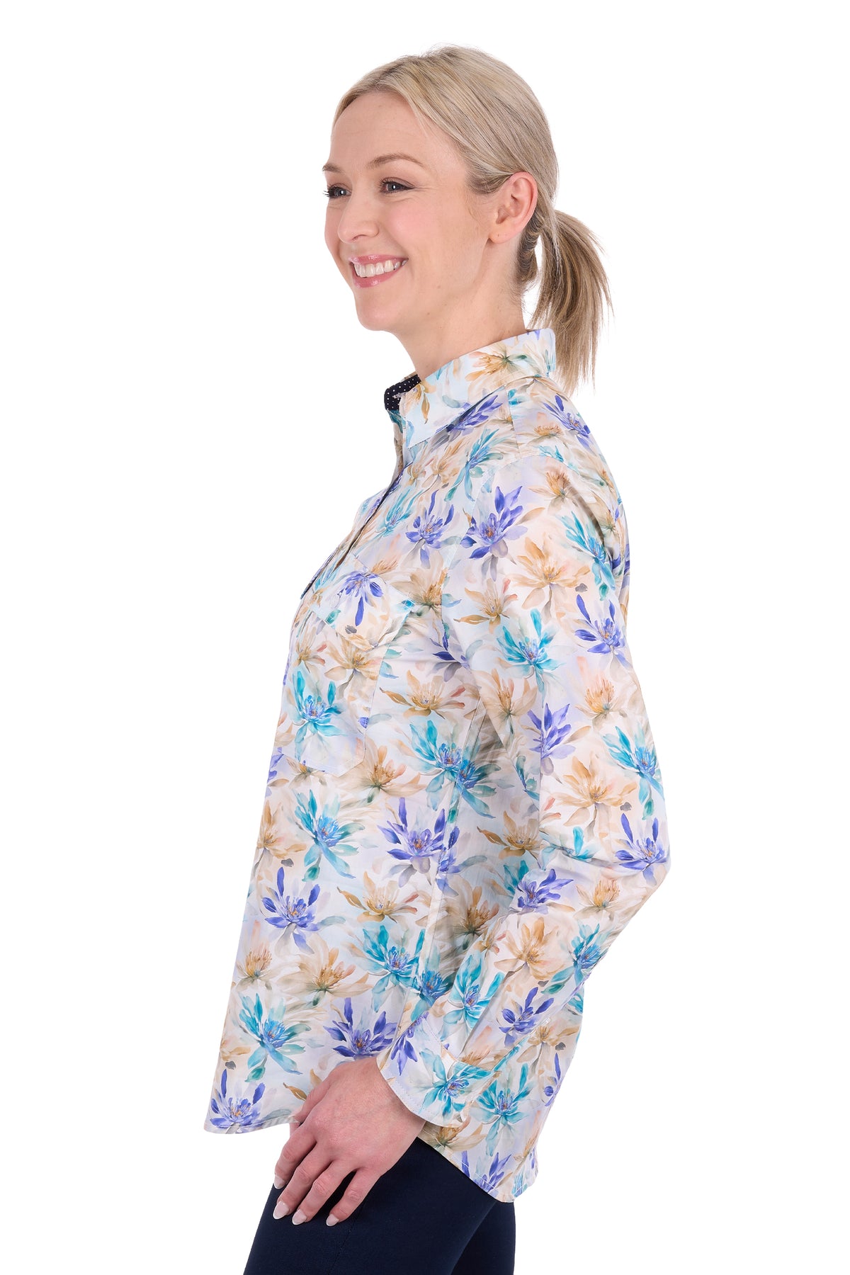 A woman shown in side profile wearing a long-sleeve collared button-up shirt with a blue, purple, and tan floral pattern on a white background.