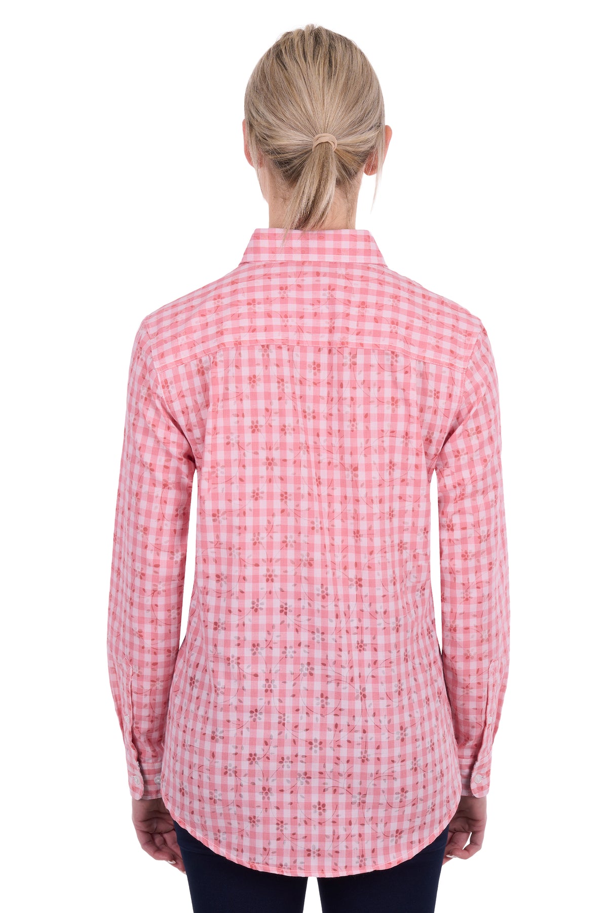 A woman viewed from the back wearing a pink and white gingham long-sleeve button-up shirt, paired with dark pants, against a plain white background.