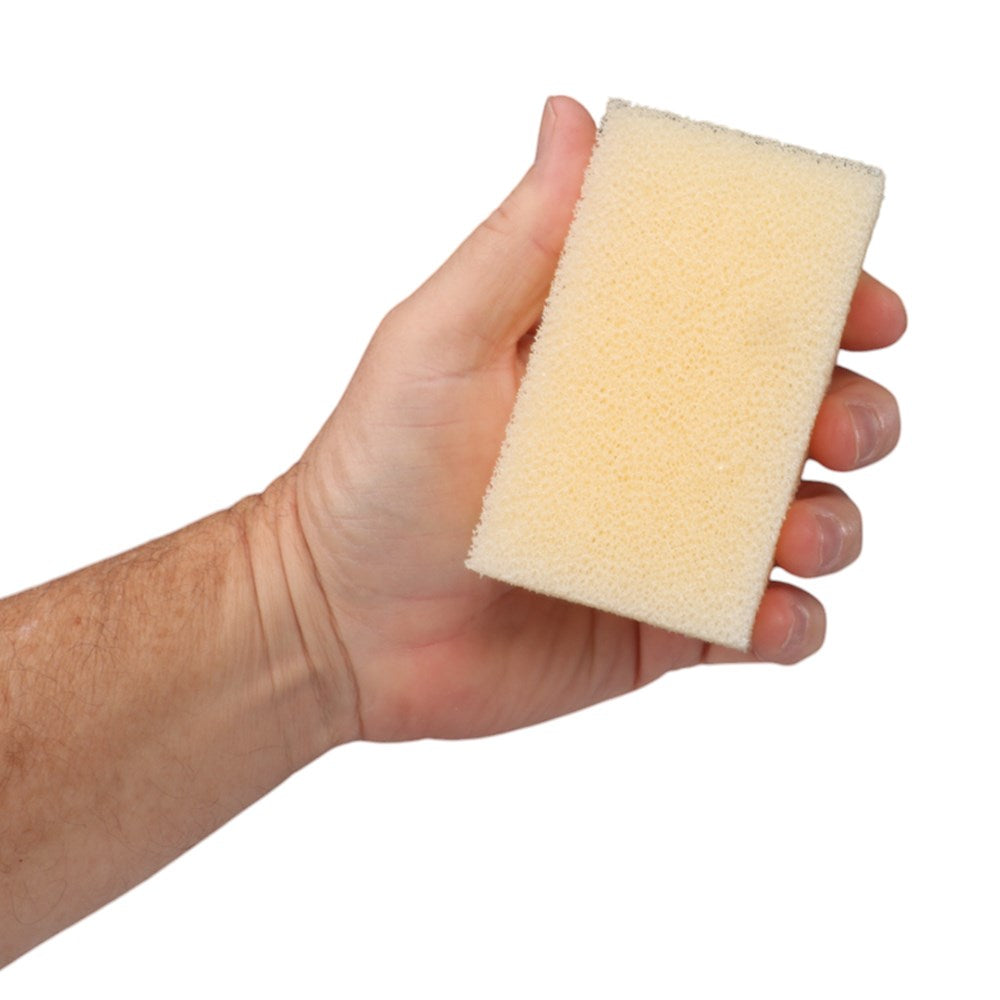 B.K. Smith Felt Hat Care Kit. Hand holding a beige sponge against a white background