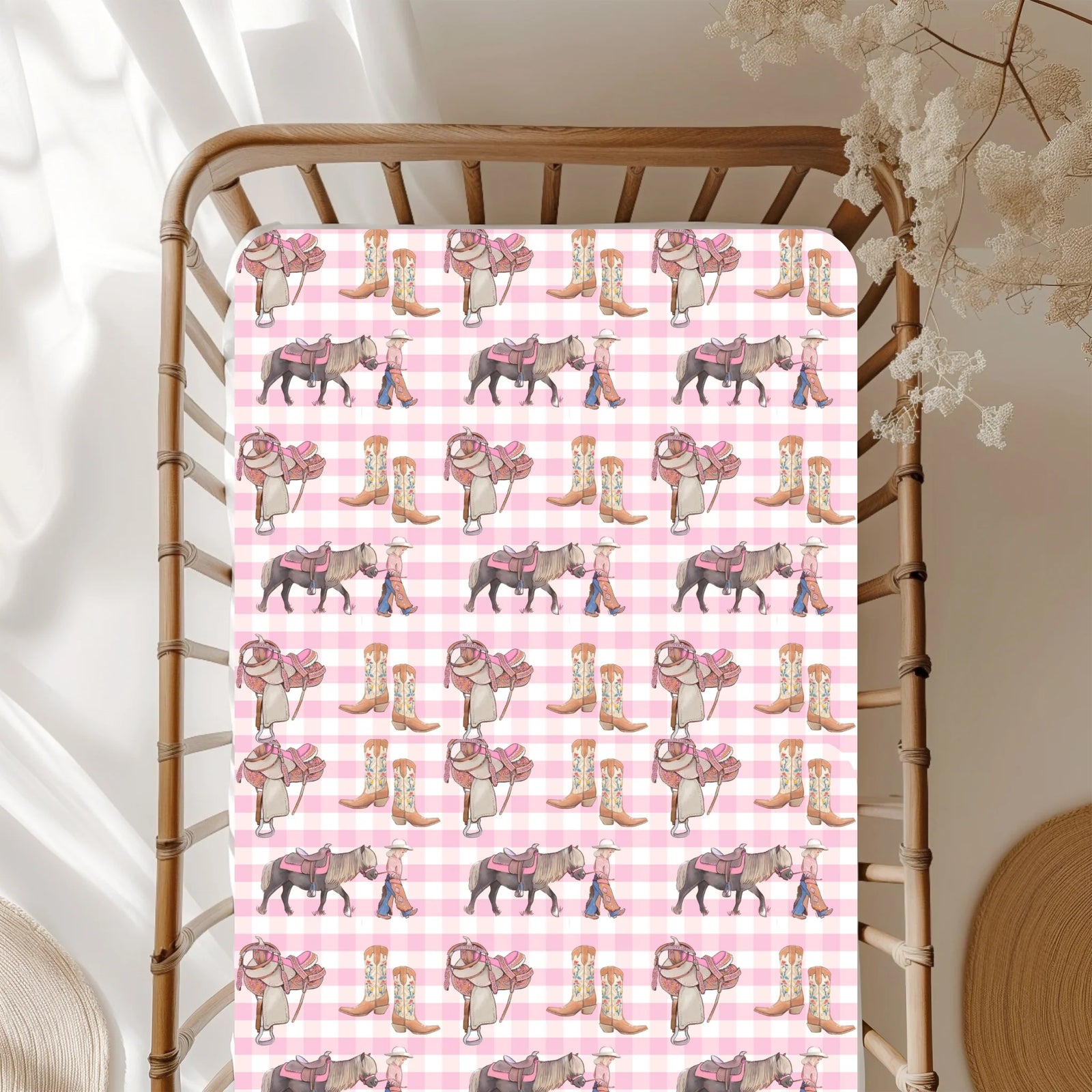 Patterned pink and white checkered fabric with cowboy boots and horses on a wooden chair.