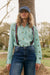 Italian Star Women's Stripe Cactus Shirt. Person wearing a green and white striped shirt with suspenders and a blue cap outdoors.