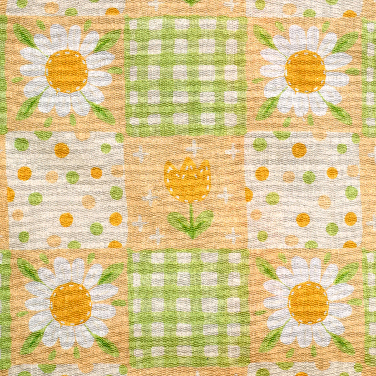 Patchwork pattern with daisies, polka dots, and checkered squares on a peach background.