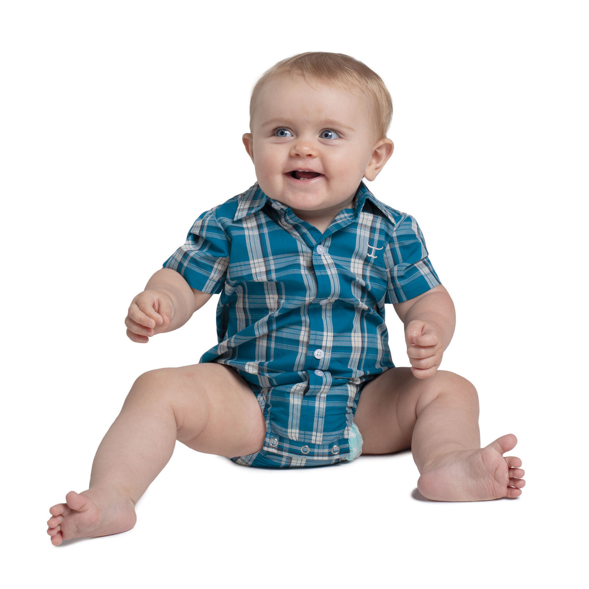 Baby wearing a blue plaid outfit on a white background