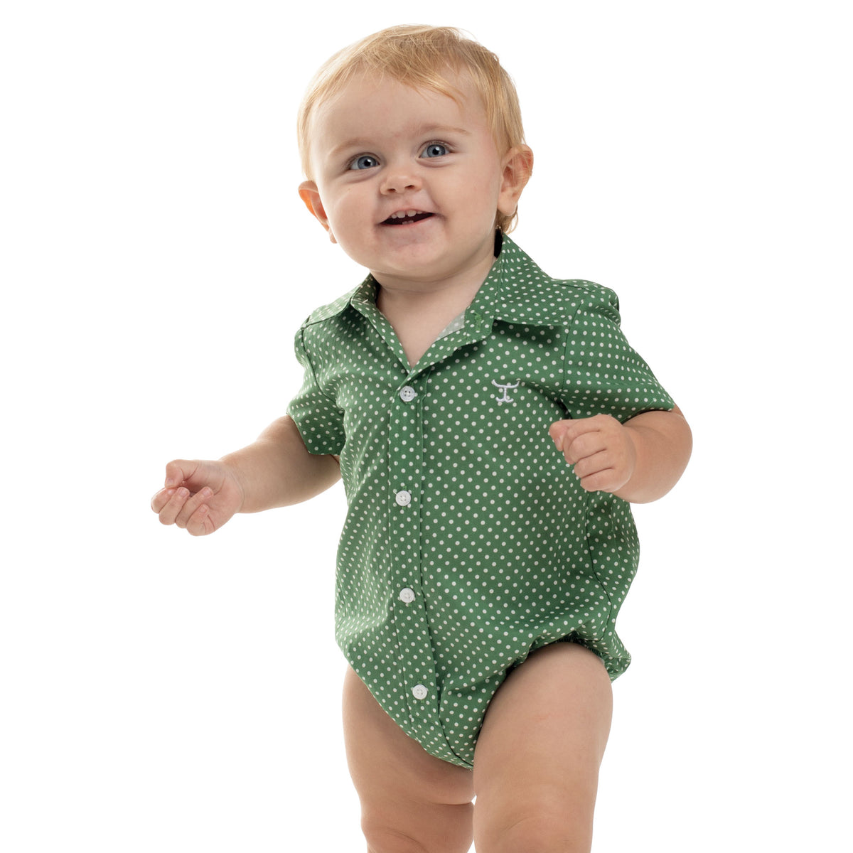 Baby wearing a green polka dot shirt on a white background