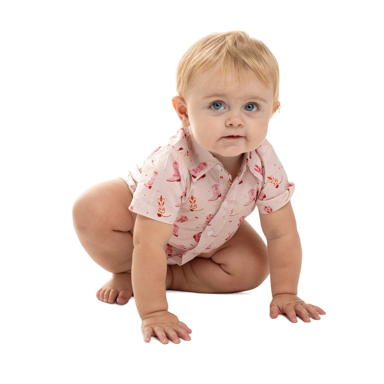 Baby wearing a pink floral outfit on a white background