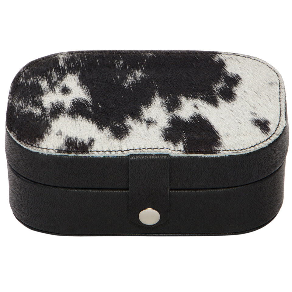 Cowhide Travel Jewellery Box. Jewelry box with black and white cowhide pattern on a white background