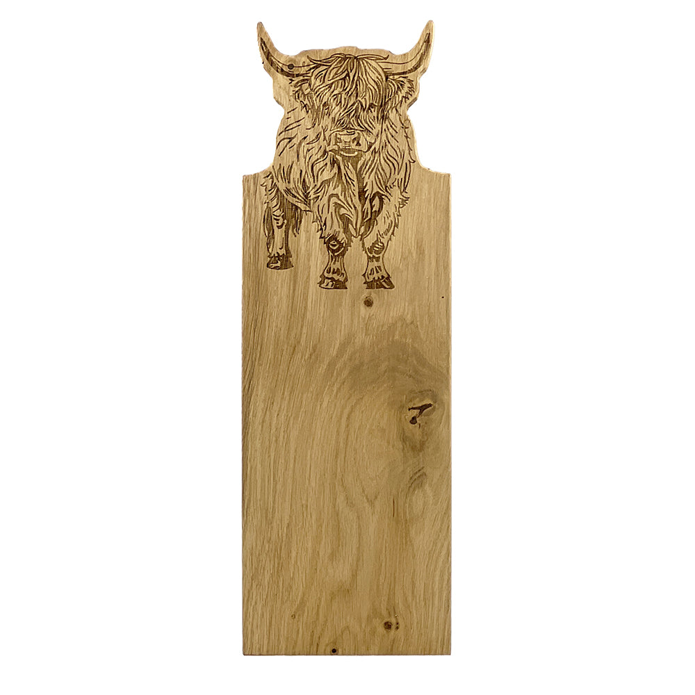 Wooden board with a highland cow engraving on a white background
