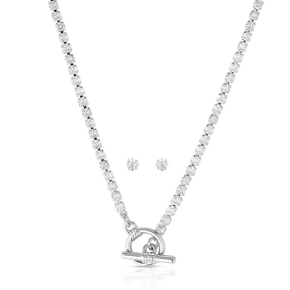 Silver necklace and earrings set on a white background