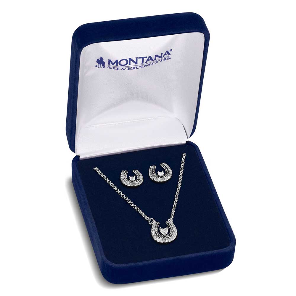Montana Silversmith the Lovely and Lucky Horseshoe Jewelry Set features a beautifully detailed horseshoe pendant on a split chain, adorned with cubic zirconia crystals that encircle the shoe and a beaded edge with black antiquing along the inside.