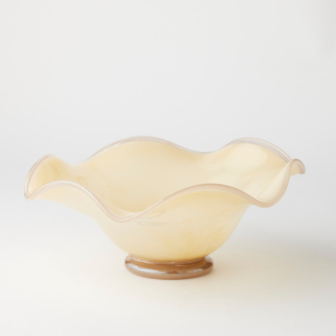 Cream-colored glass bowl on a light gray background