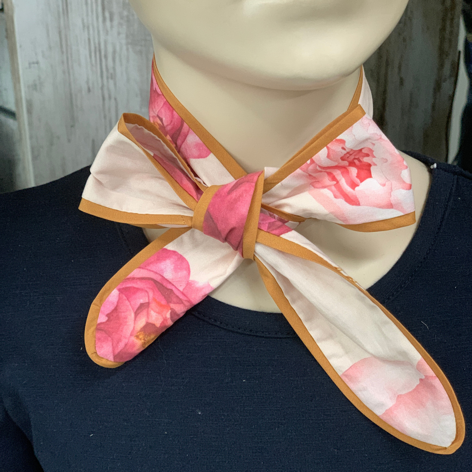 Kitty Fordè Peonie Horse Printed Necktie. Floral bow tie on a mannequin with a dark background