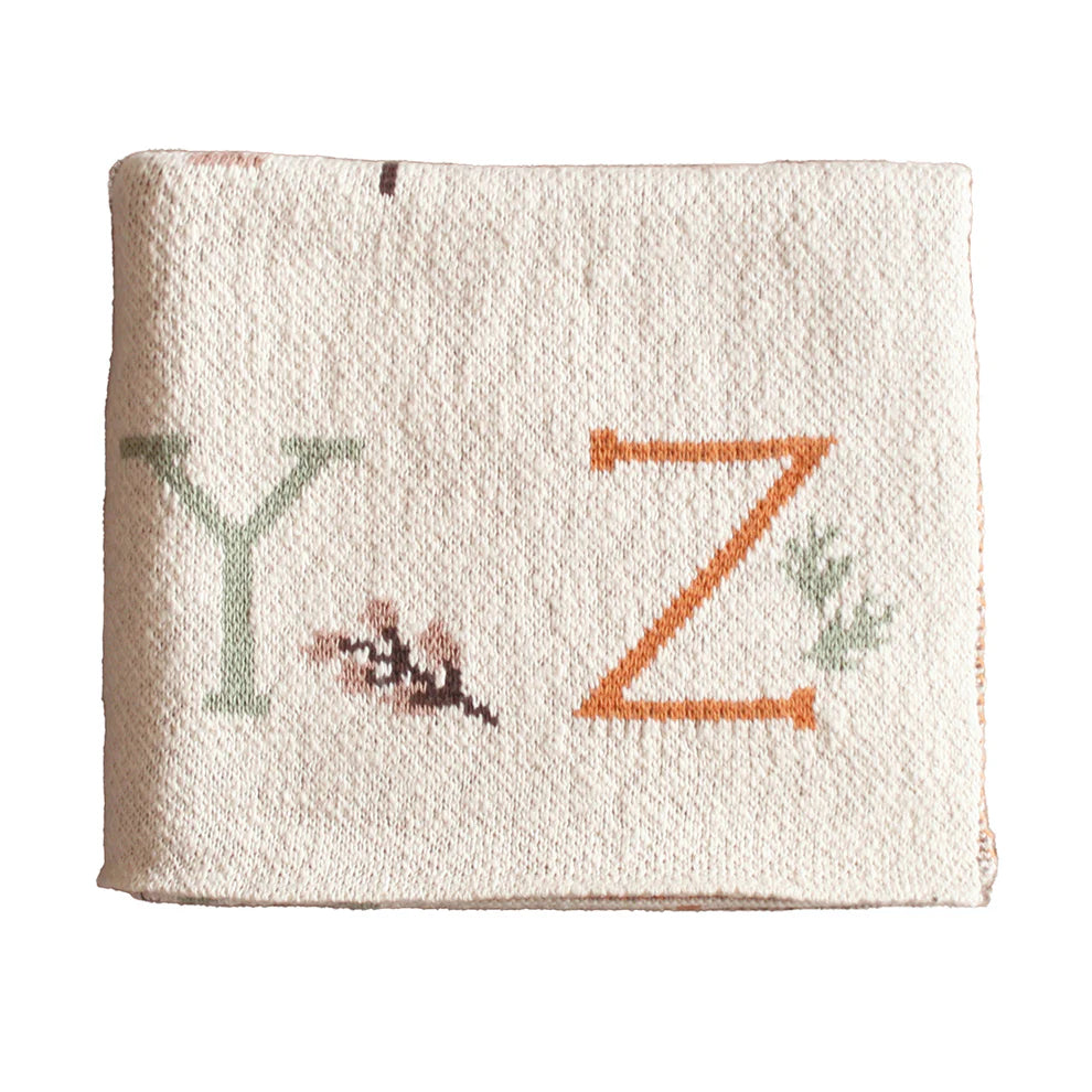 Textured fabric with embroidered letters 'Y' and 'Z' on a white background
