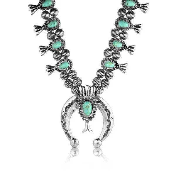 Silver and turquoise beaded necklace on a white background