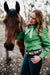 Kitty Fordè Karina Plain Linen L/S Shirt. Woman in a green shirt standing next to a horse outdoors