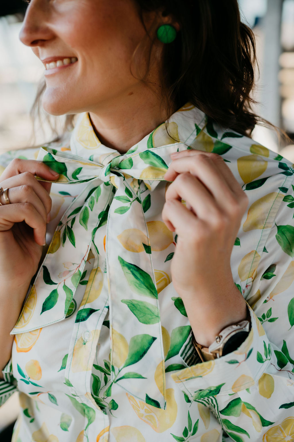 Kitty Fordè Kerrie Printed L/S Shirt. Person wearing a shirt with a lemon and leaf pattern, smiling outdoors.
