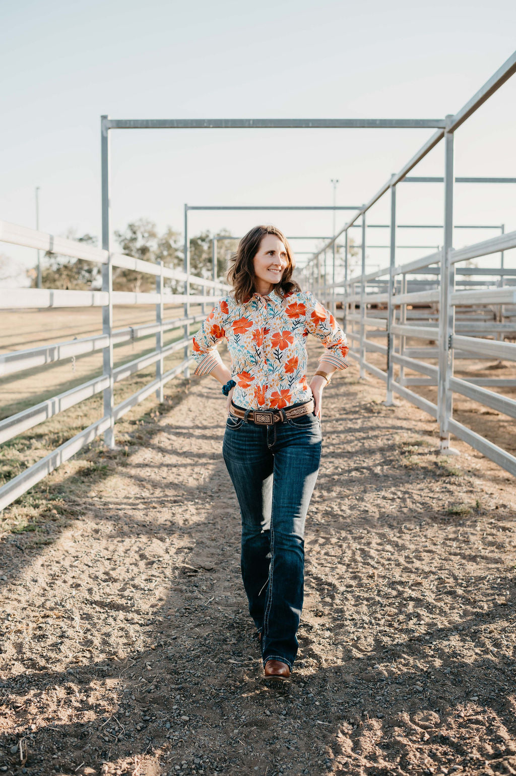 Kitty Fordè Margie Printed L/S Shirt. Woman wearing a colorful floral blouse outdoors