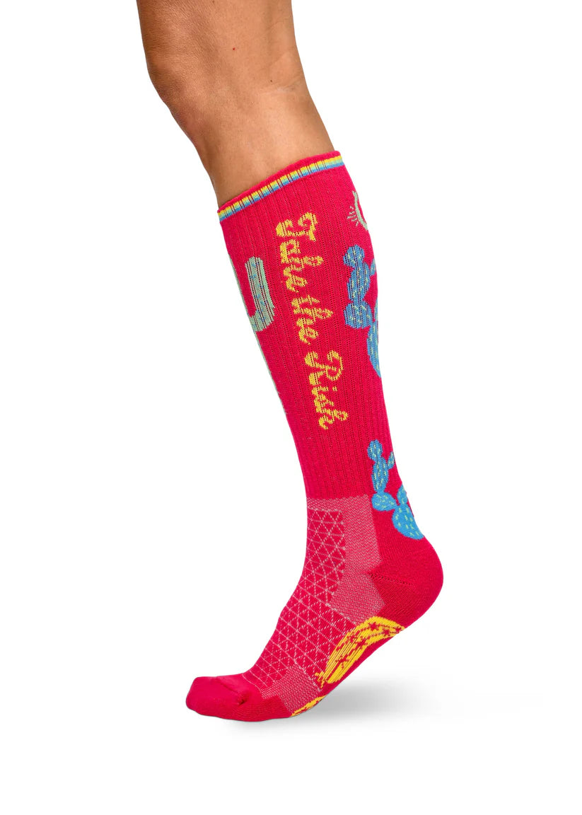 Lucky Chuck Take the Risk Performance Socks. Red sock with gold text and blue floral design on a white background