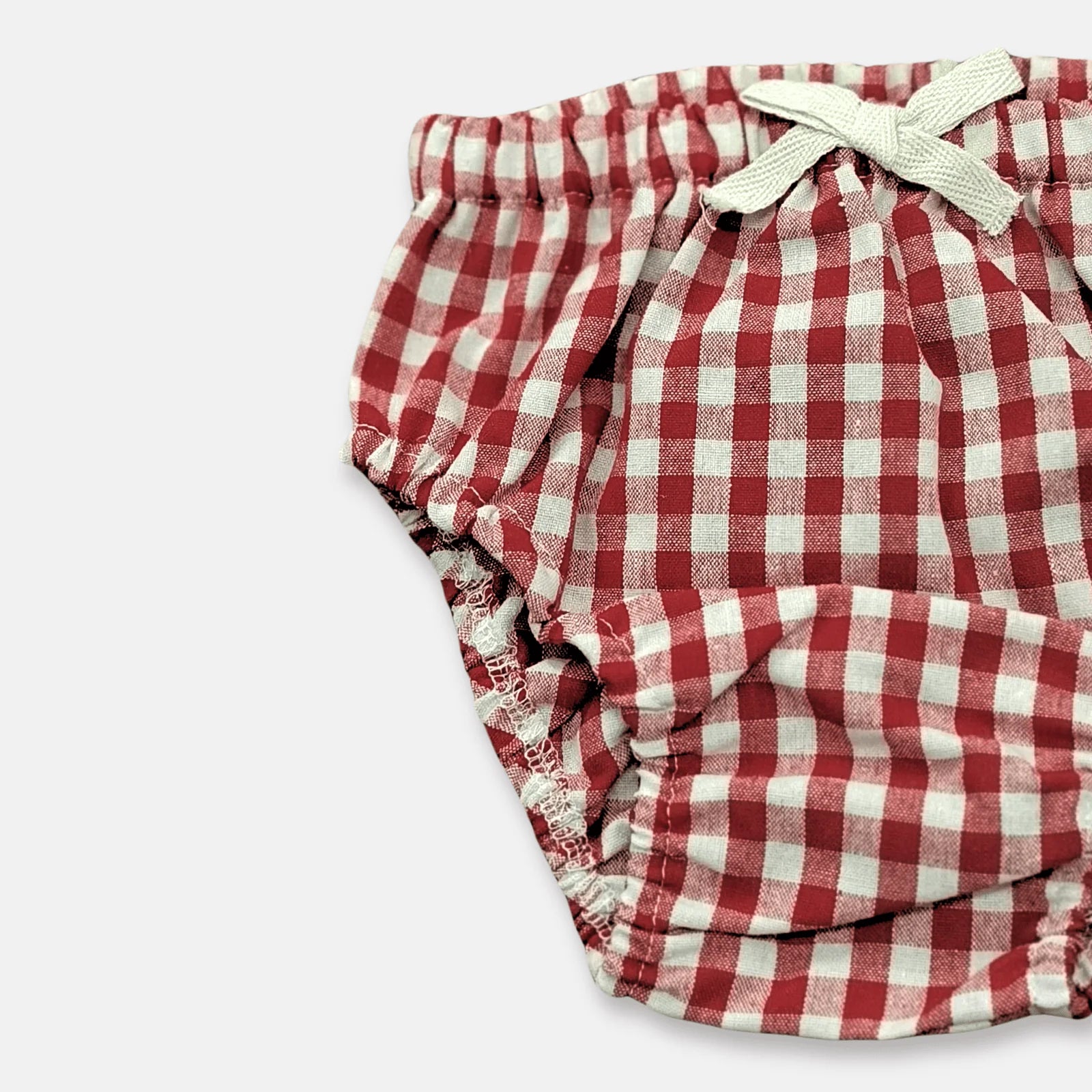 Love Henry Infant Girl's Pilcher. Red and white checkered baby girl's diaper cover with a elastic waistband and decorative white tie.