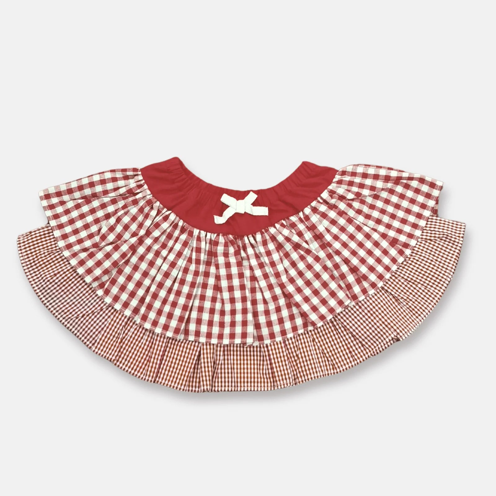 Love Henry Infant Girl's Frilly Pilcher Skirt. A frilly pilcher skirt with a red gingham pattern and an elastic waistband designed for infant girls.