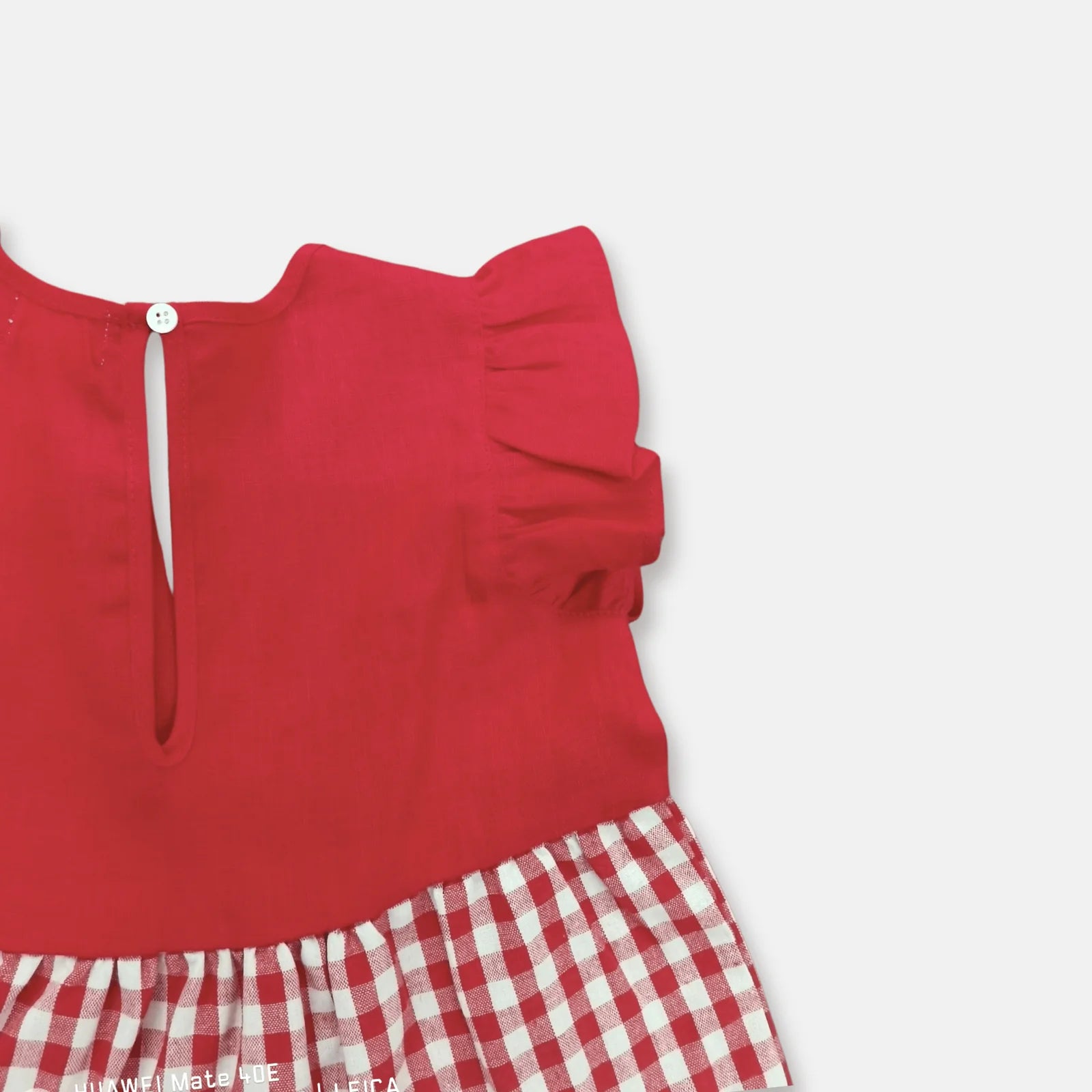 Love Henry Girl's Ivy Dress. A girl's red dress with red and ivory checkered and gingham patterns, designed with a round neckline and short sleeves.