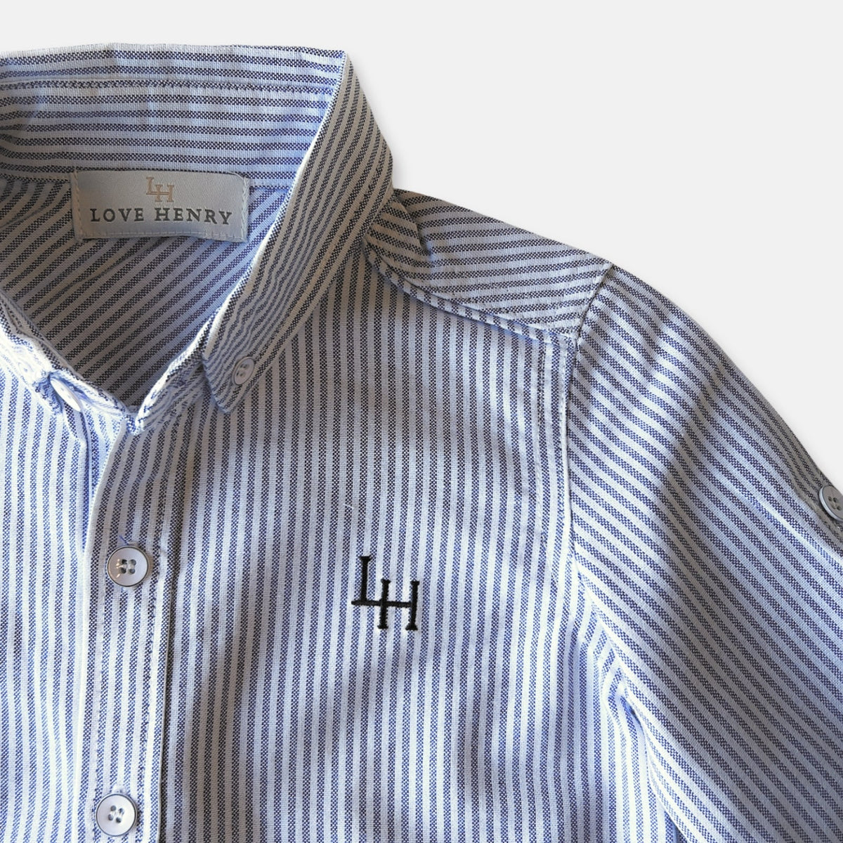 Love Henry Boy's Oxford Dress Shirt. Blue and white striped children's shirt with collar and button details.
