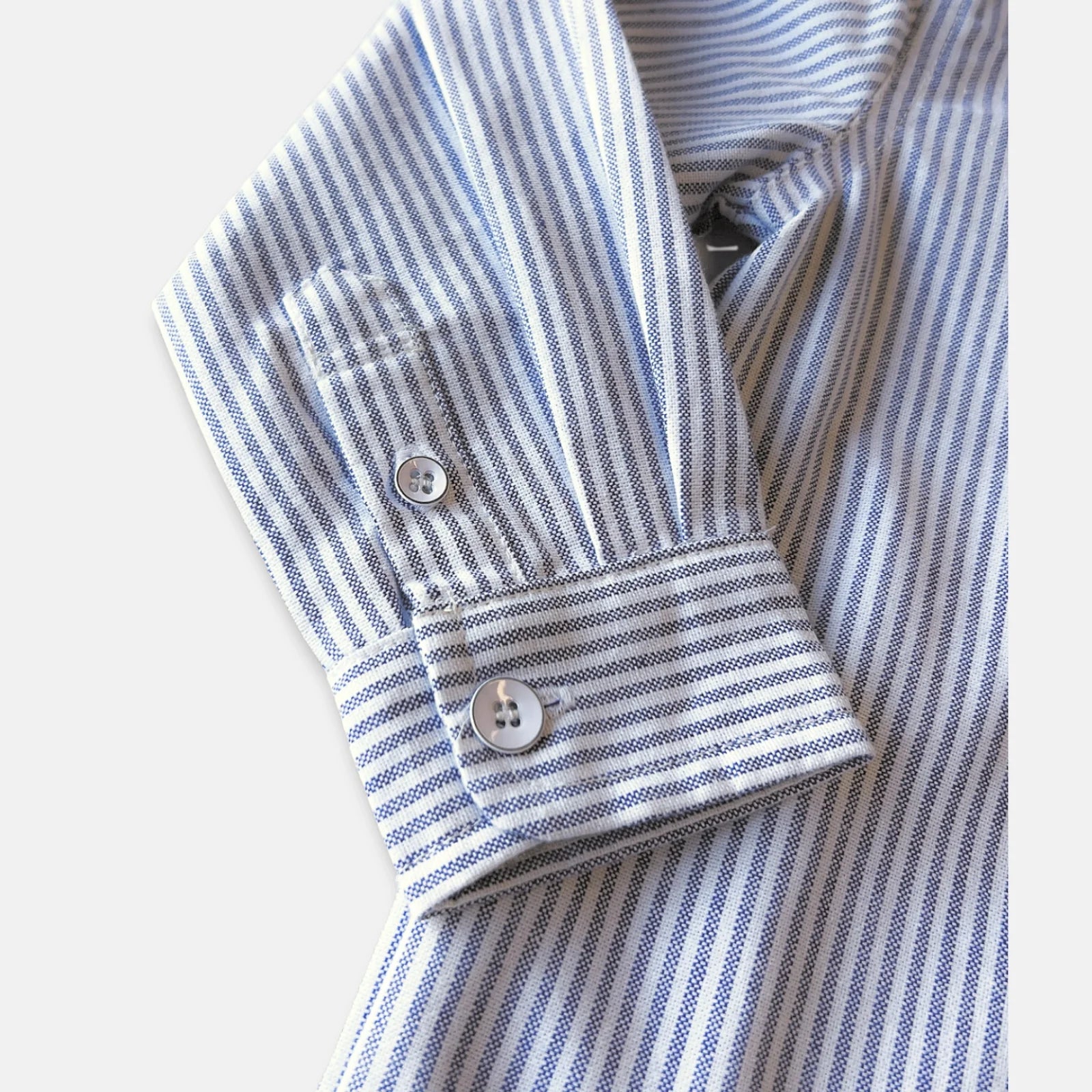 Love Henry Boy's Oxford Dress Shirt. A button-down, long-sleeved boy's Oxford dress shirt with a collar, button placket, and roll-up sleeves with a sleeve tab, in blue and white stripes.