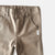 Love Henry Boy's Chino Pants. Close-up of brown pants with a button and label on a plain background.