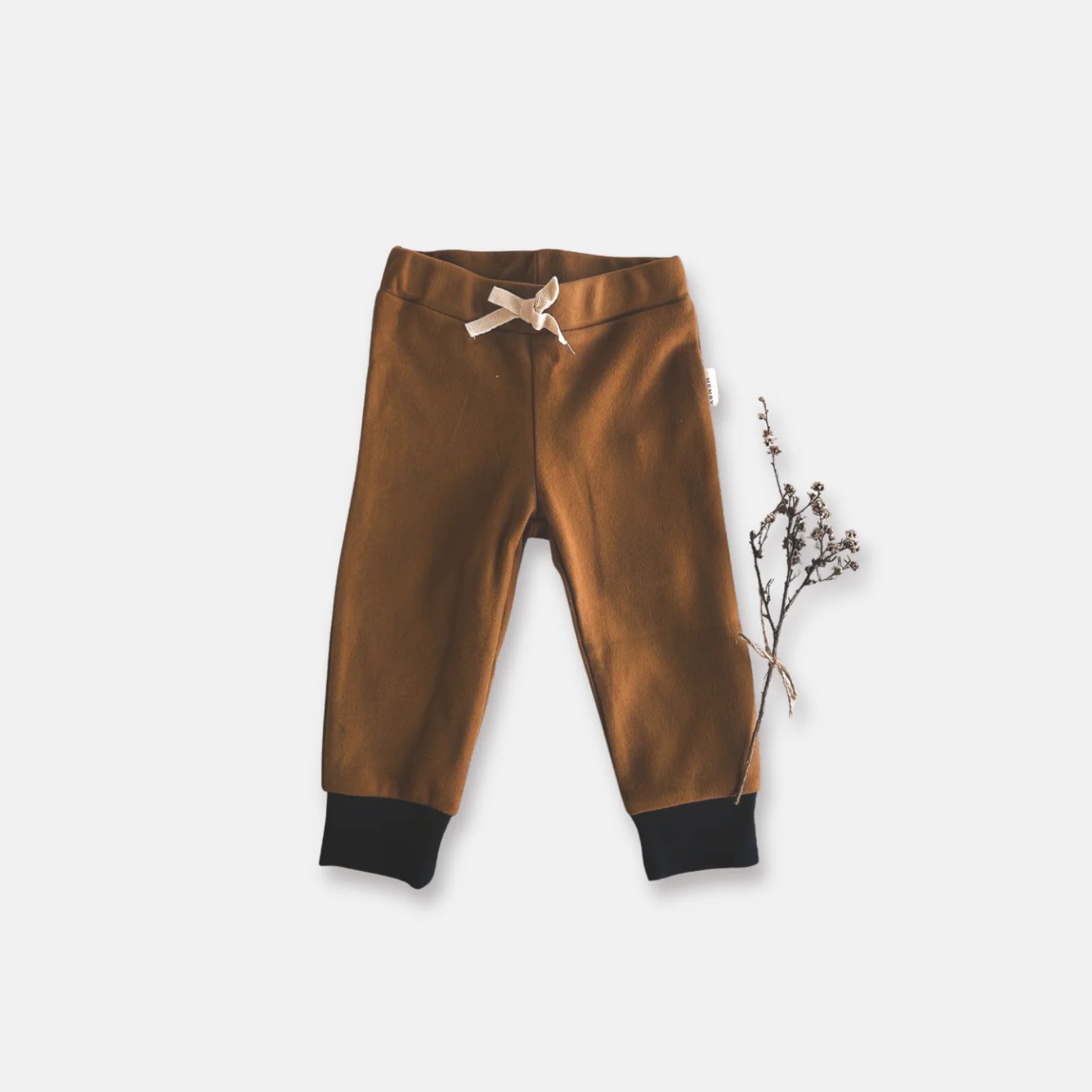Love Henry Baby Boy's Comfy Pants. Brown children's pants with a bow on a light gray background