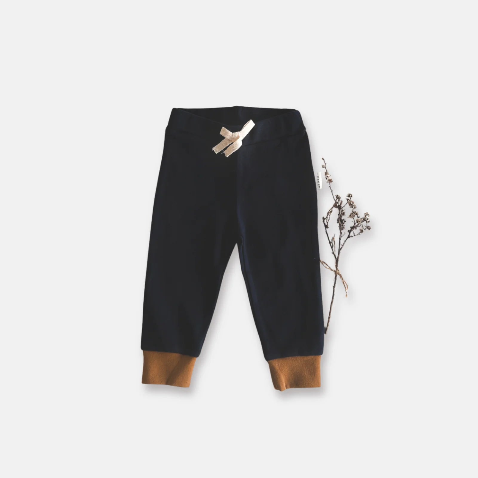 Love Henry Baby Boy's Comfy Pants. Navy pants with brown cuffs on a light gray background