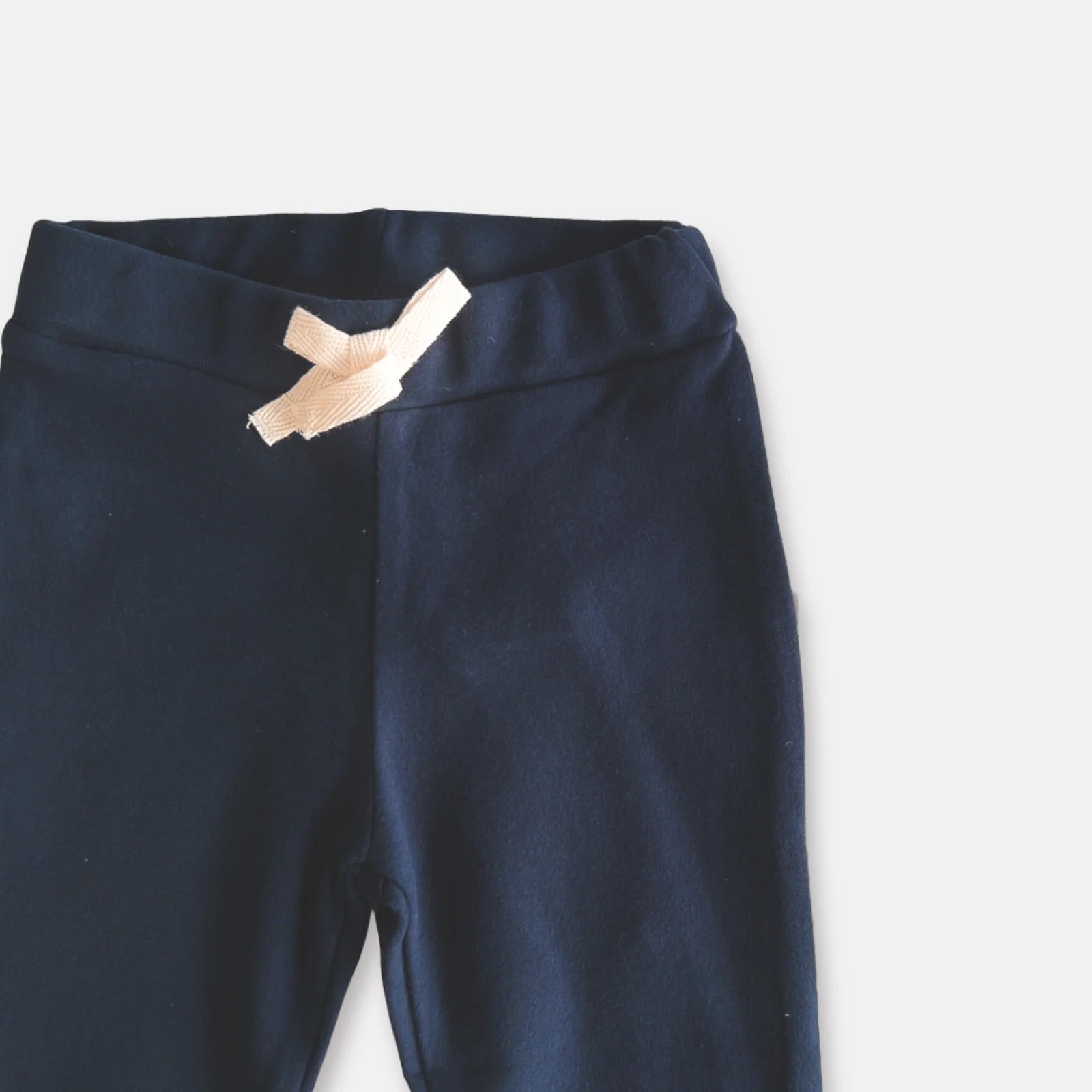 Love Henry Baby Boy's Comfy Pants. Navy pants with brown cuffs on a light gray background