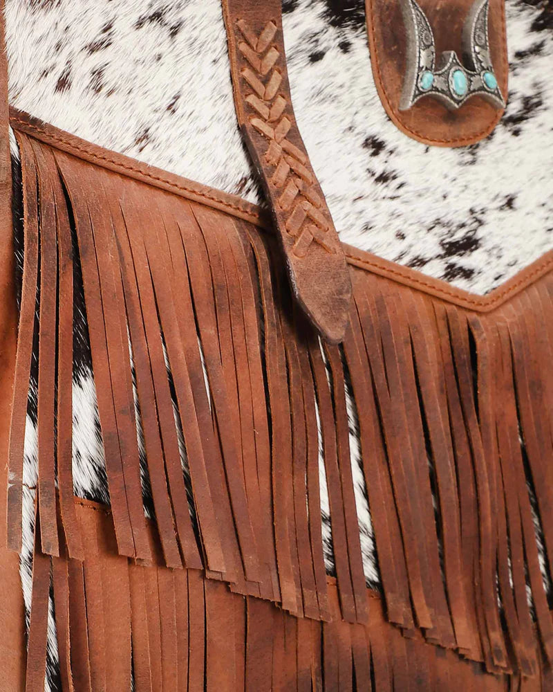 Loyal West Hide And Fringe Large Cowhide Western Handbag. Close-up of a leather bag with fringe and cowhide pattern