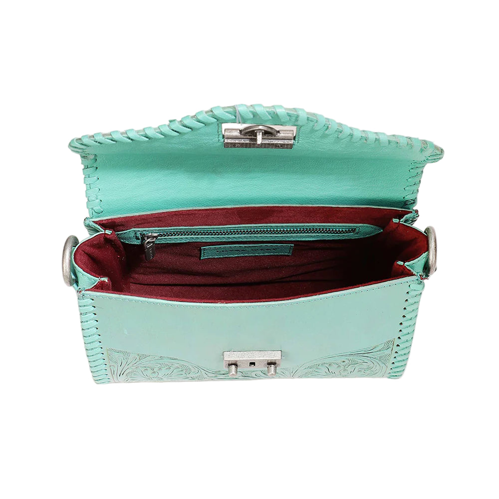 Loyal West Daisy Mini Western Bag. Turquoise handbag with red interior on a light beige background