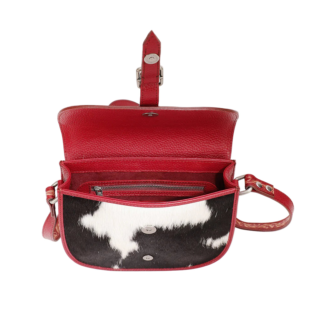 Loyal West Aurelia Mini Western Handbag. Red leather handbag with black and white cowhide interior on a light gray background