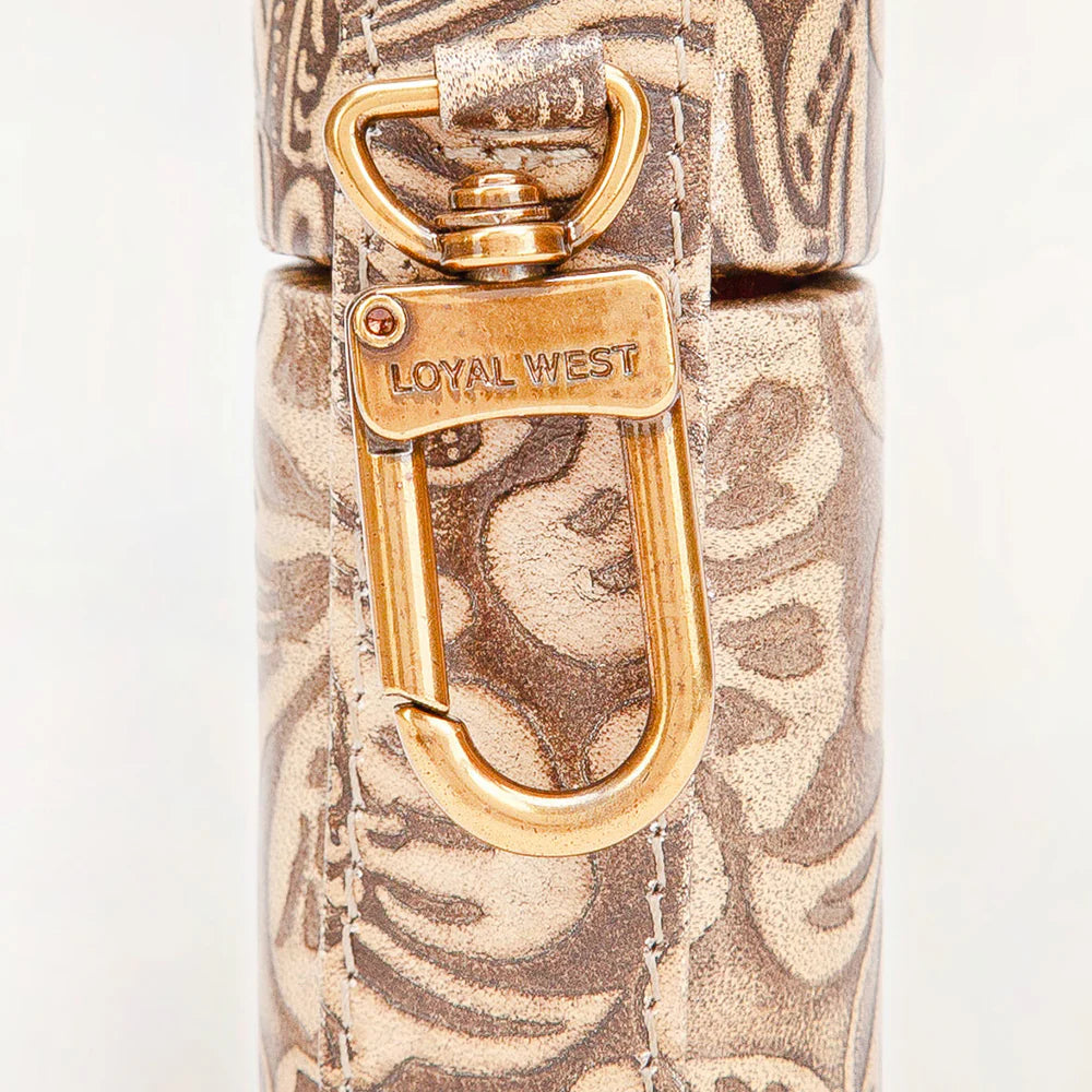 Close-up of a patterned product with a gold handle and 'LOYAL WEST' branding.