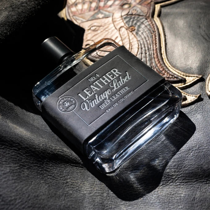 Perfume bottle labeled 'Leather Vintage Label' on a textured surface