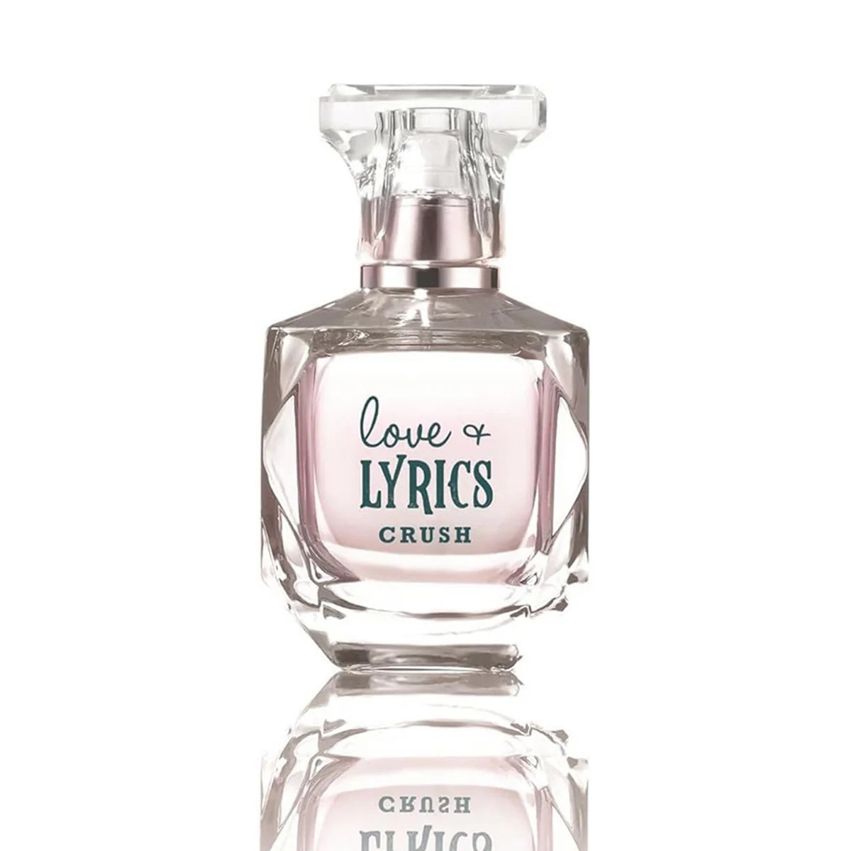 A clear glass perfume bottle with a faceted cap, containing a pale pink liquid. The front label reads 'love LYRICS CRUSH' in dark teal script and block lettering.