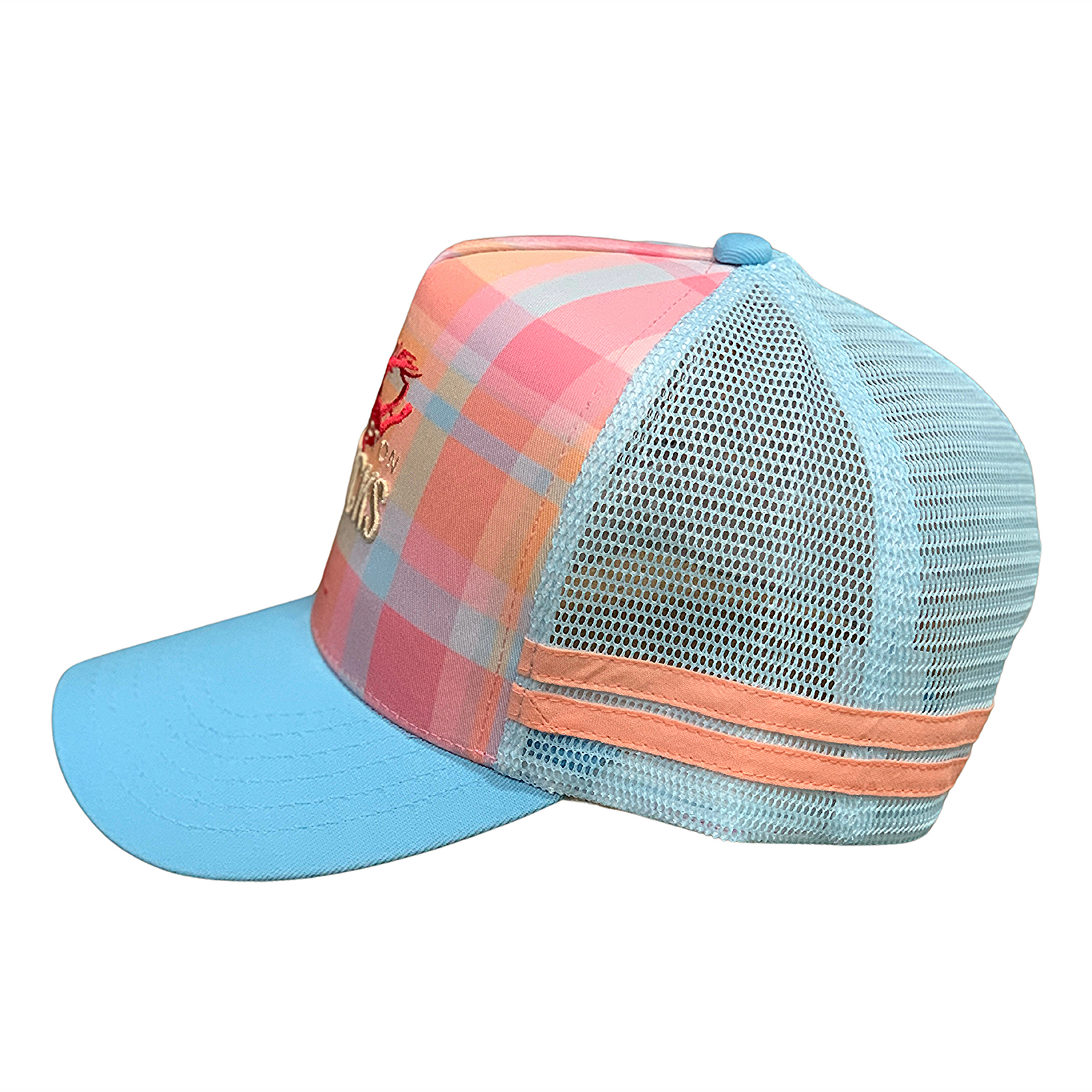 Rocky Mavericks Pink Plaid Trucker Cap. A trucker cap with a pink and blue plaid pattern and 'Mavericks' text embroidered on the front.